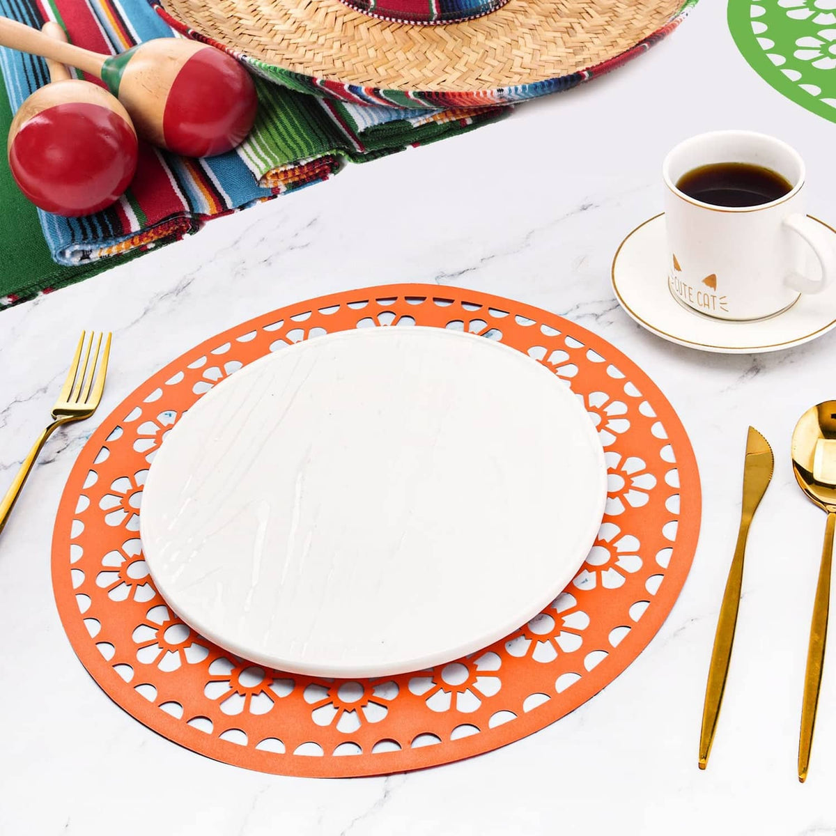 Orange circular paper place mat with cutout lace-style pattern under a white plate