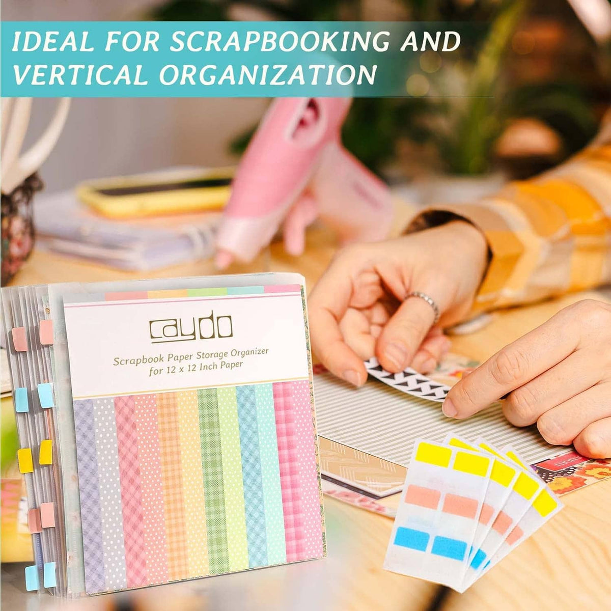 Scrapbook paper storage organizer with sticky tabs beside patterned paper stack