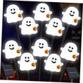 White smiling ghost solar pathway lights with jack-o'-lantern buckets on ground stakes