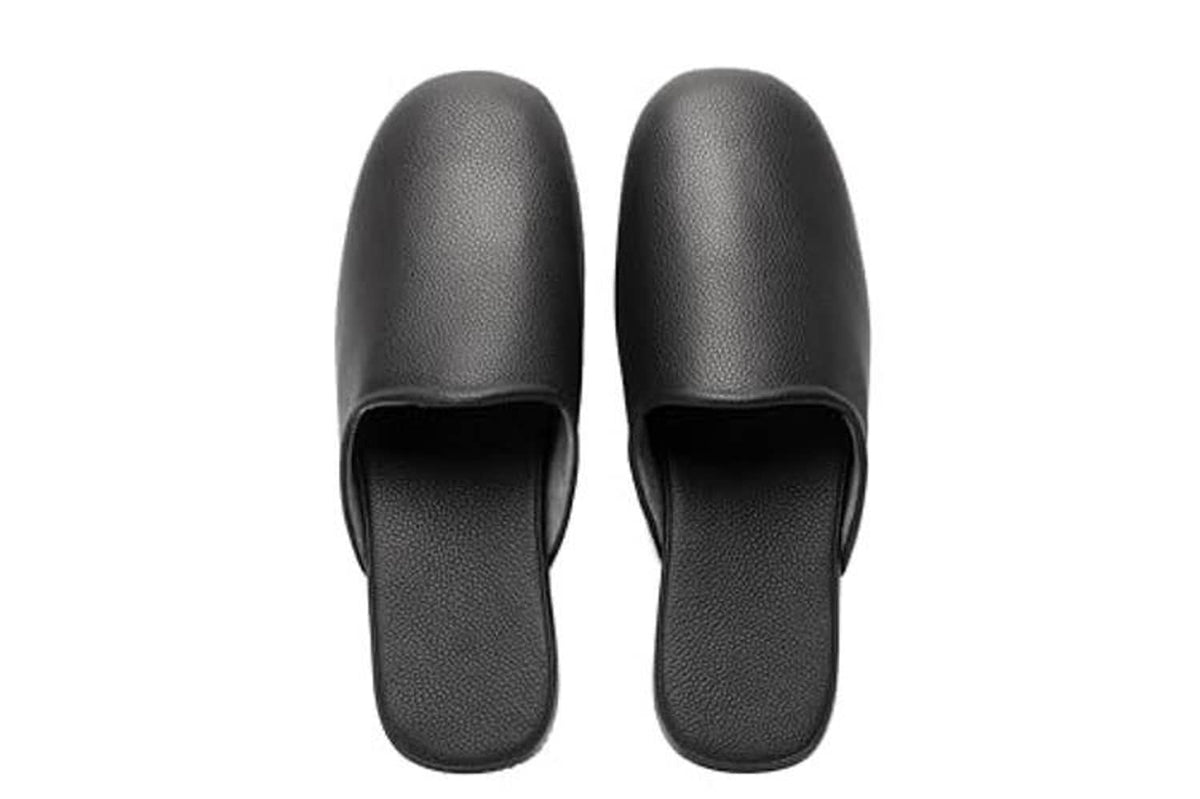 Black leather slip-on slippers viewed from above, open heel and wide vamp