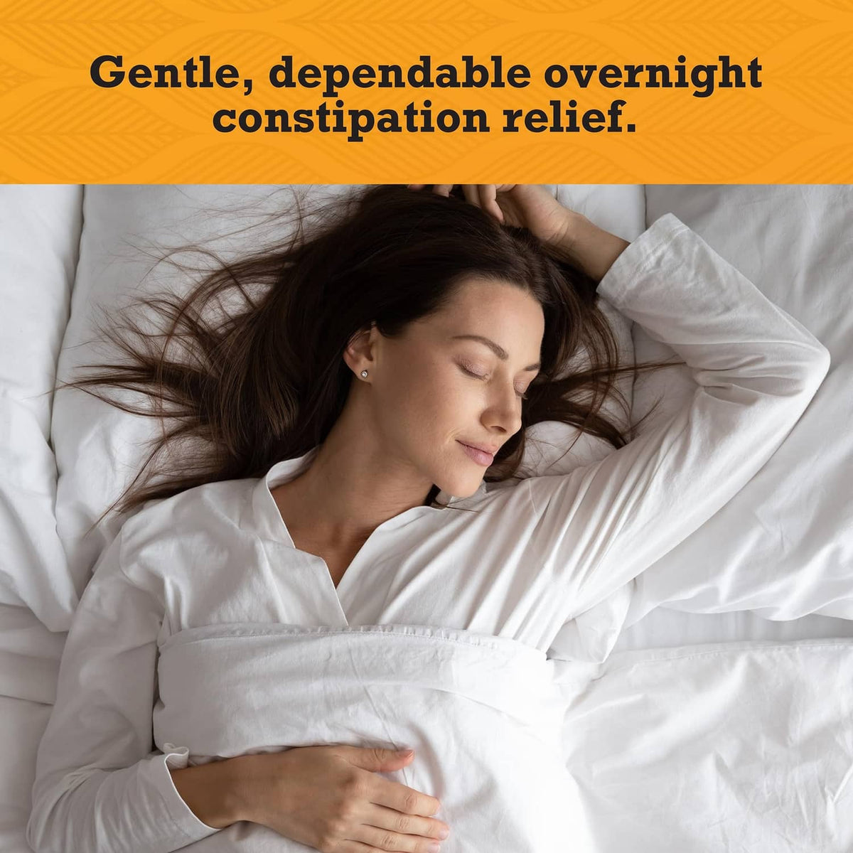 Person lying in bed with one hand on their stomach, resting