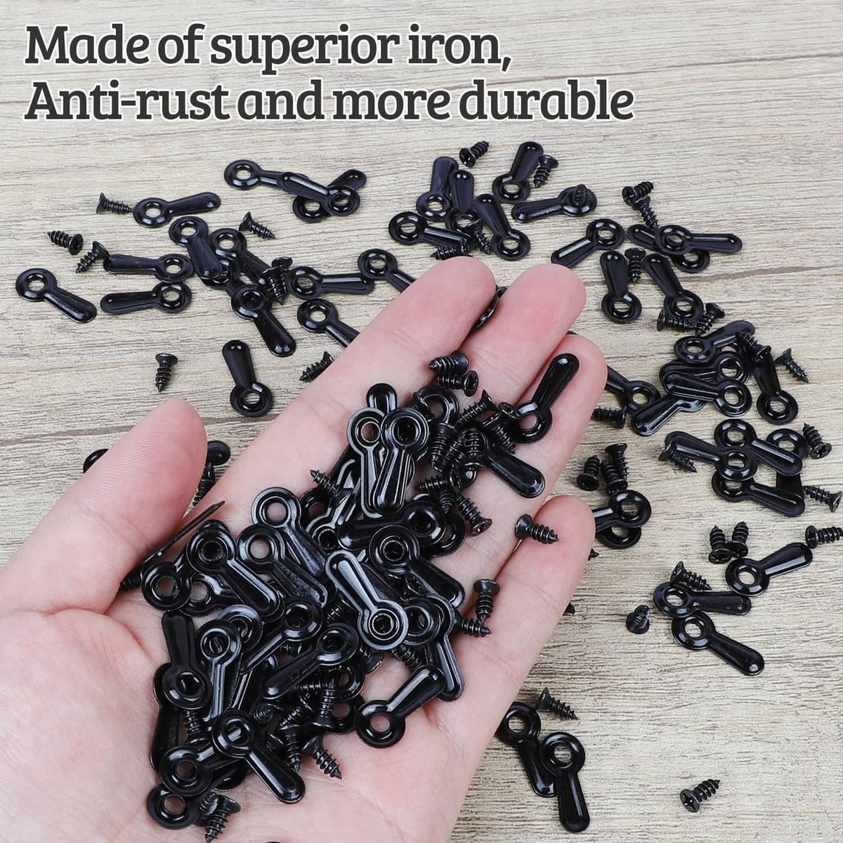 Hand holding black picture frame turn button fasteners and screws