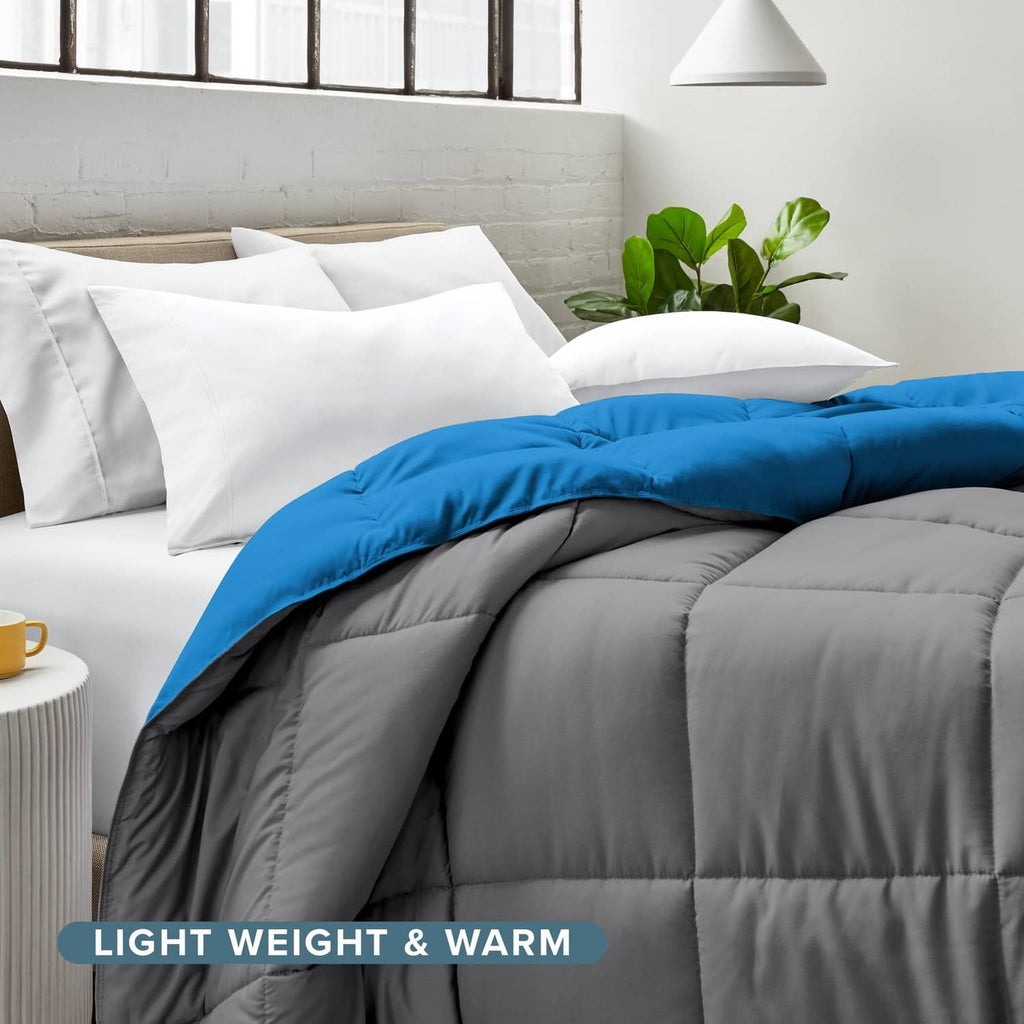 Twin XL reversible comforter draped with blue cover and grey reverse on bed