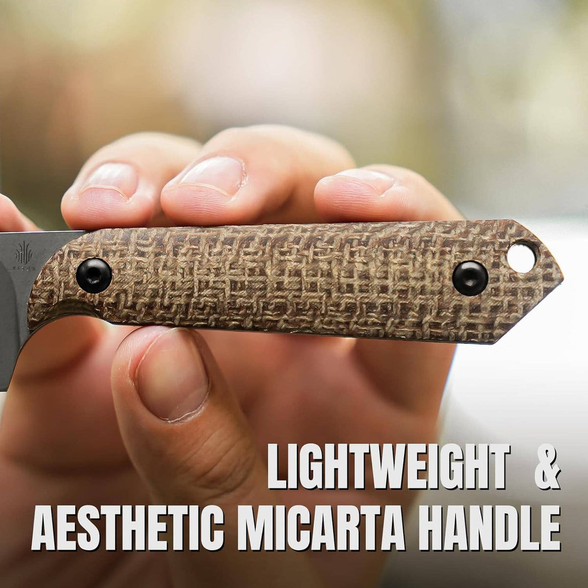 Close-up of tan micarta handle with black screws on a gray fixed blade knife