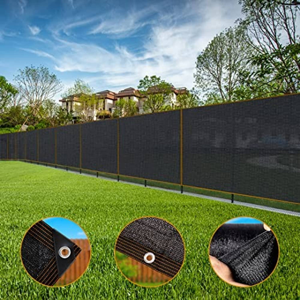 Long black shade netting panel with brown trim and grommet corners along a yard