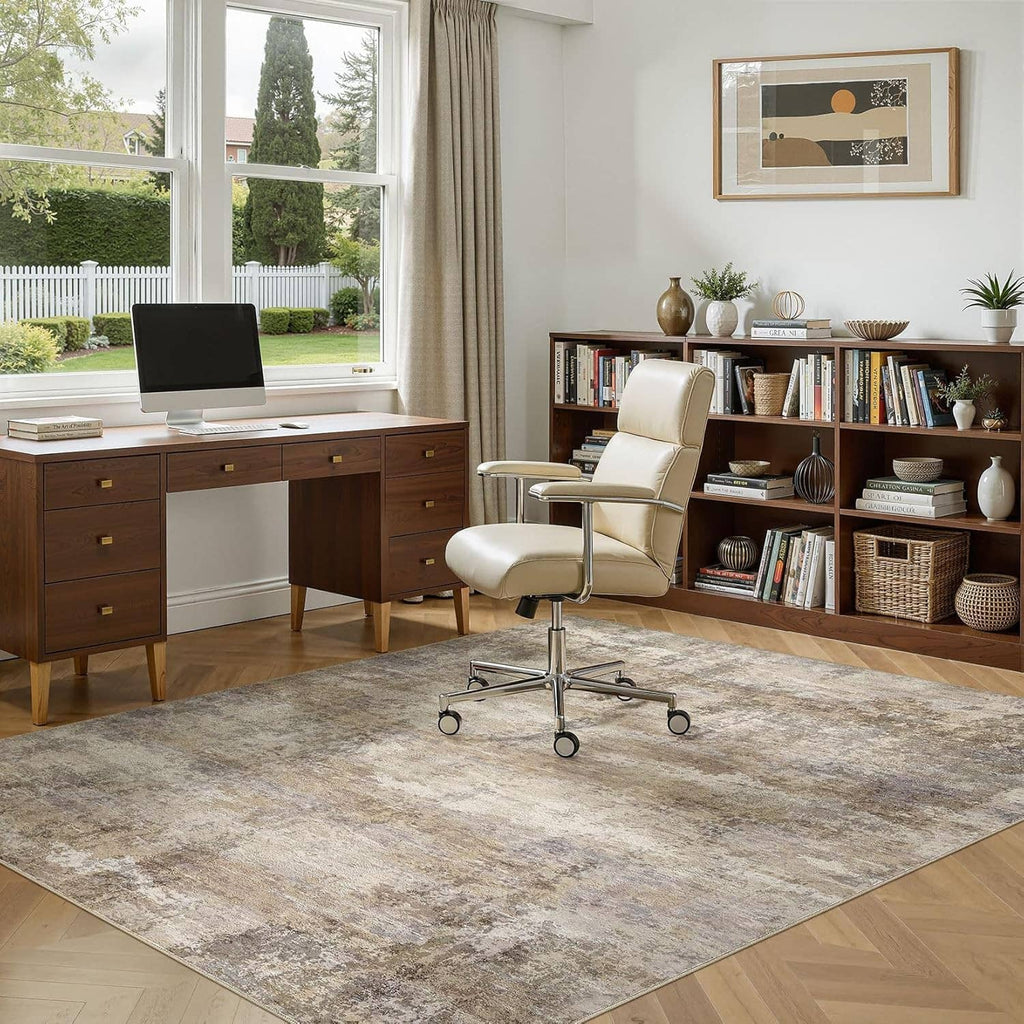 Distressed beige and gray area rug with bordered edge under office chair