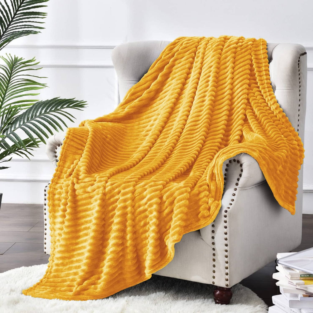Yellow ribbed fleece throw blanket draped over armchair with layered folds