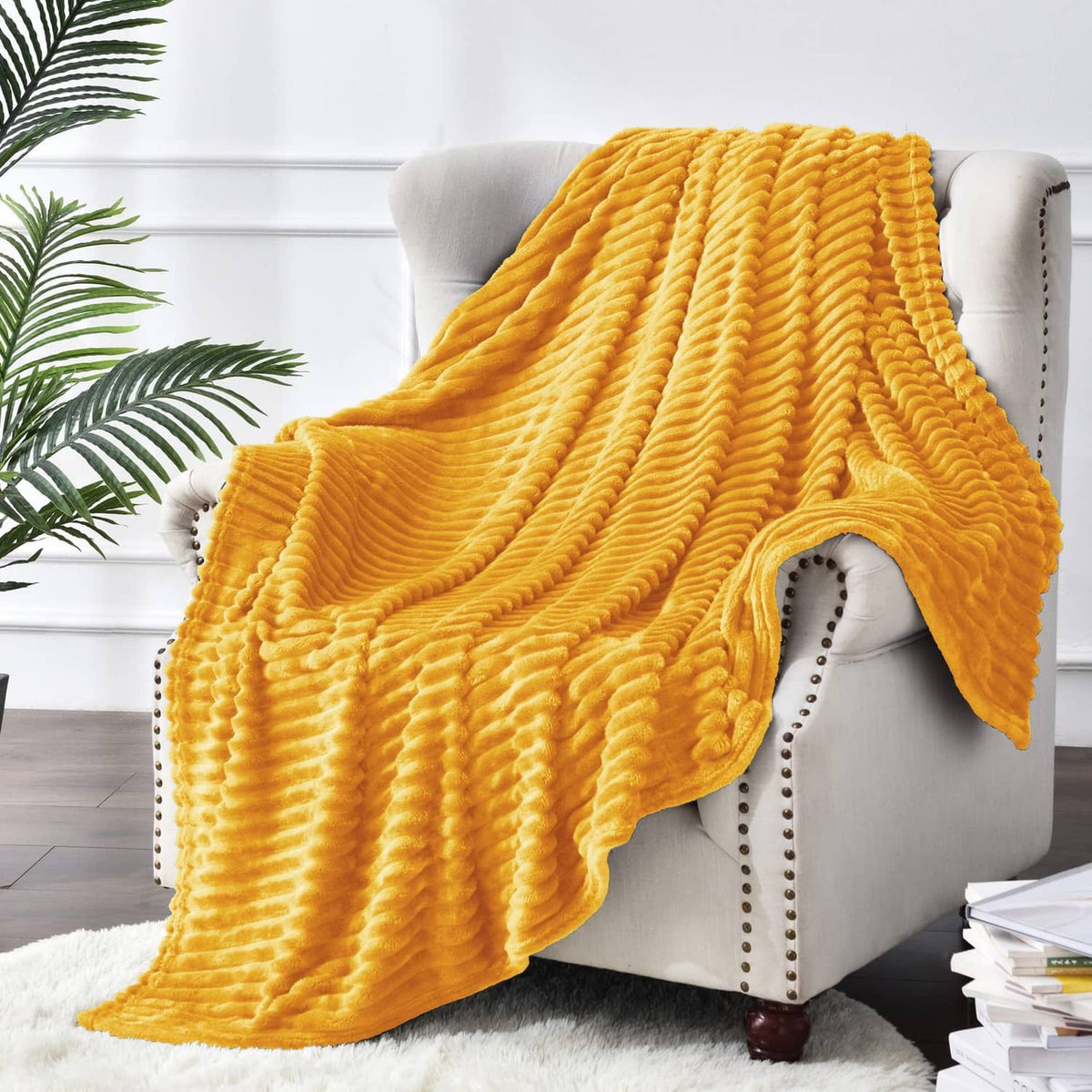 Yellow ribbed fleece throw blanket draped over armchair with layered folds