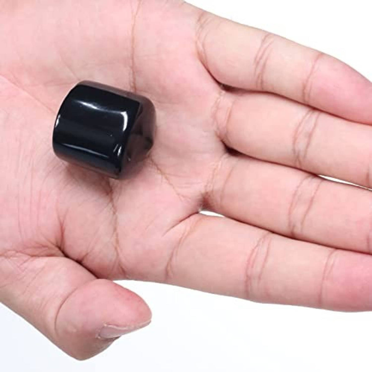 Round rubber end cap in hand, dark blue/black, smooth glossy finish