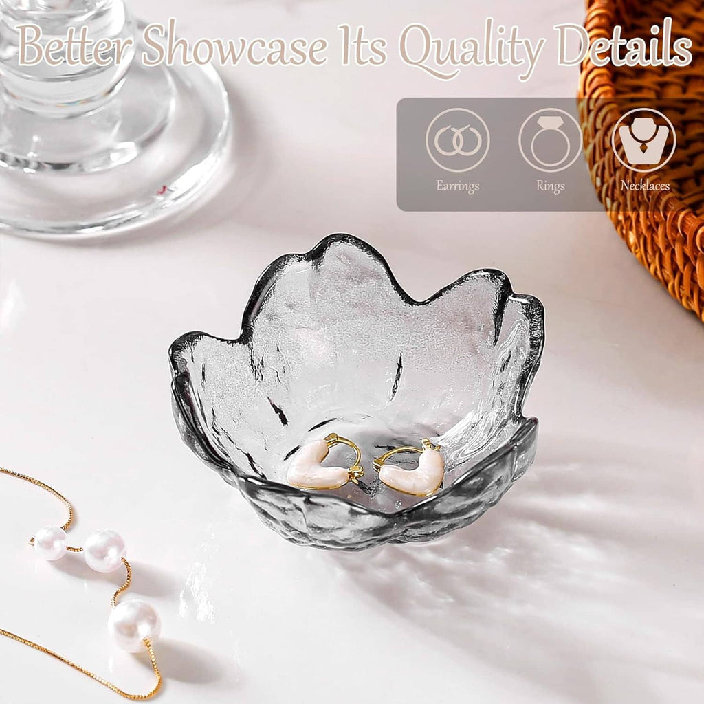 Glass jewelry trinket dish with two gold-tone opal rings, plus dangling jewelry
