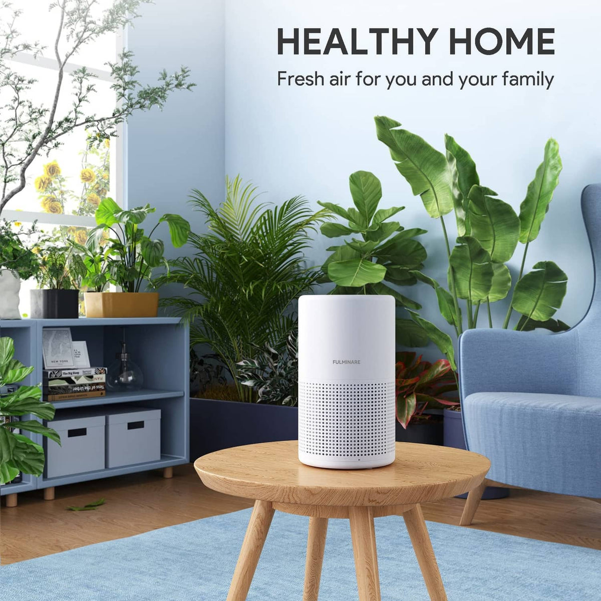 White cylindrical air purifier on a table, with top fan grille and control panel.