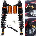 Pair of air shock absorbers with black coil springs and orange-gold reservoirs