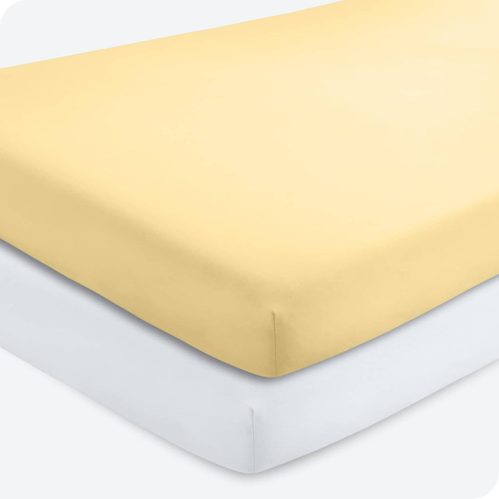 Yellow crib fitted sheet with fitted corners and elastic trim