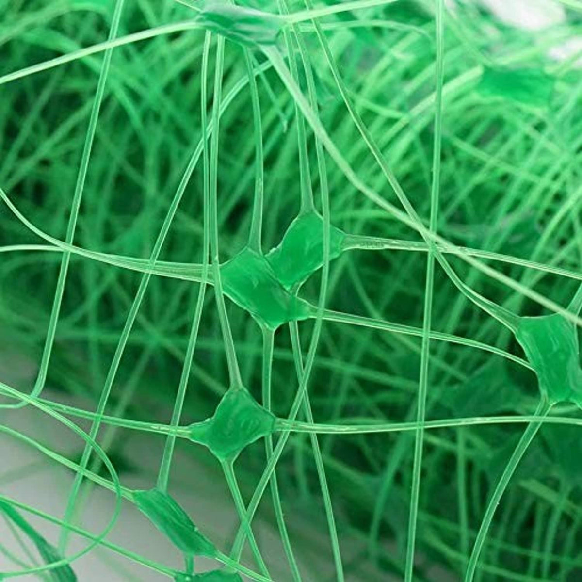 Close-up of green square mesh plant support netting fibers