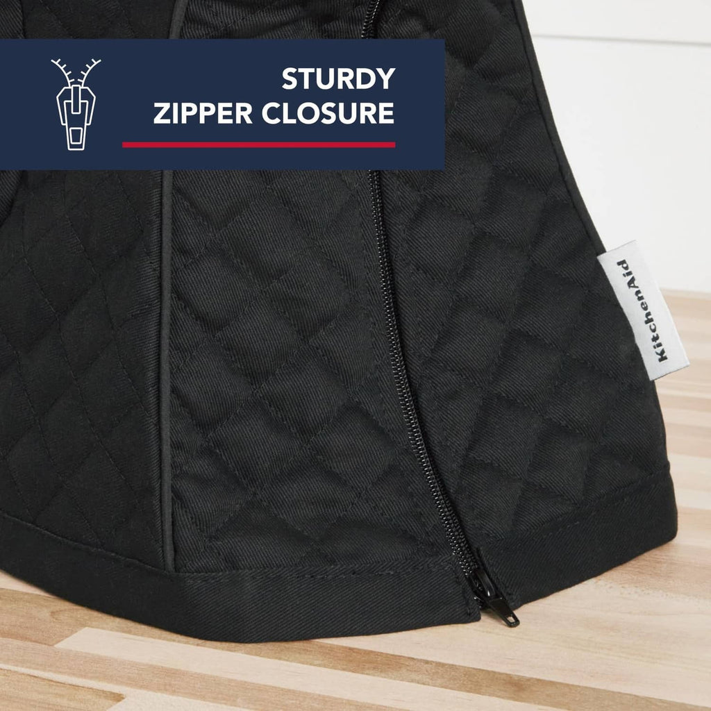 Black quilted stand mixer cover with visible zipper and side label