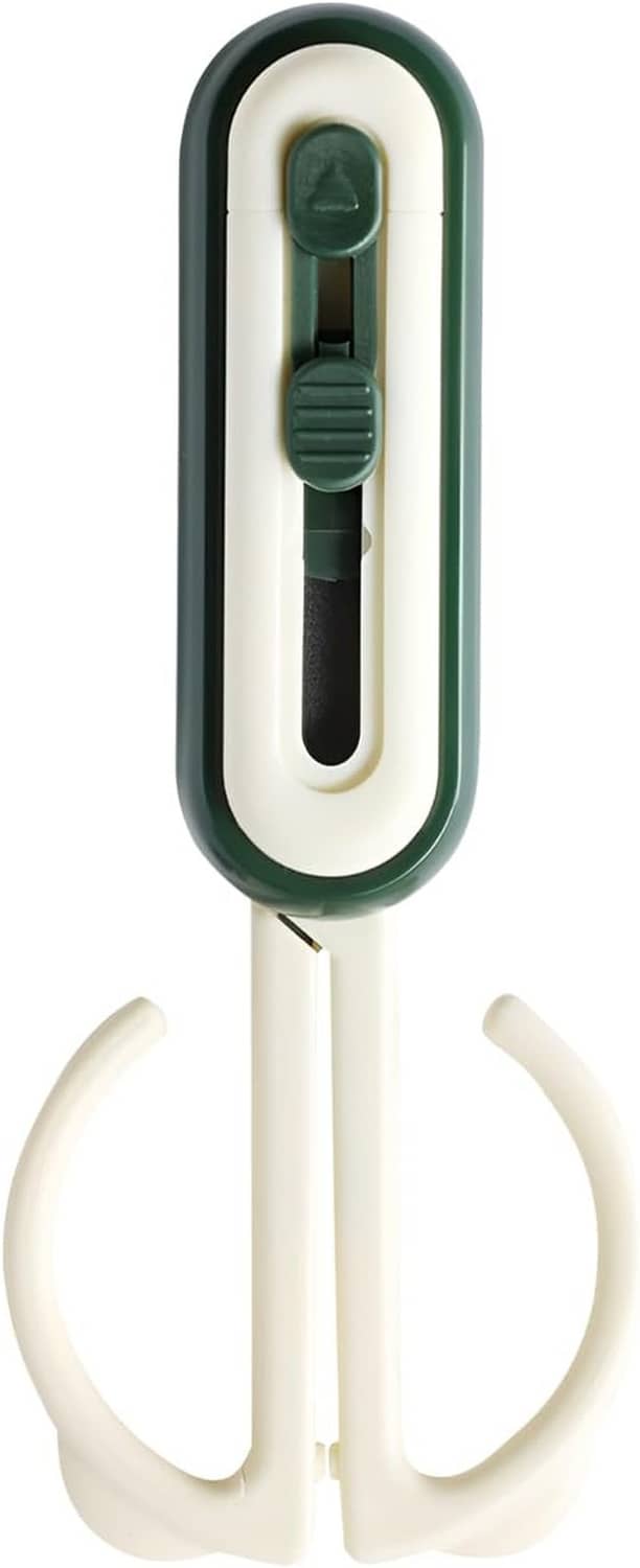 Green magnetic scissors with white loop opener base and dark blade detail.