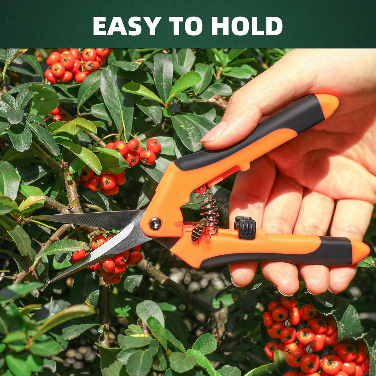 Orange stainless-steel pruning shears with black no-slip handle, held in a hand