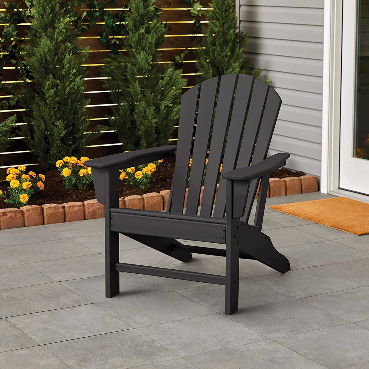 Black outdoor wooden patio chair with slatted back and arms, protective finish