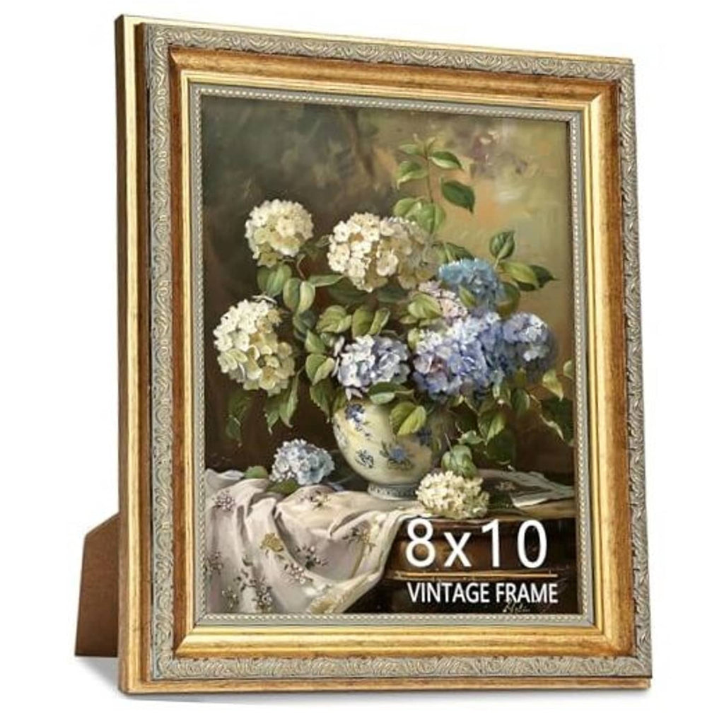 Ornate rectangular gold picture frame with distressed trim and clear glass, holding floral artwork