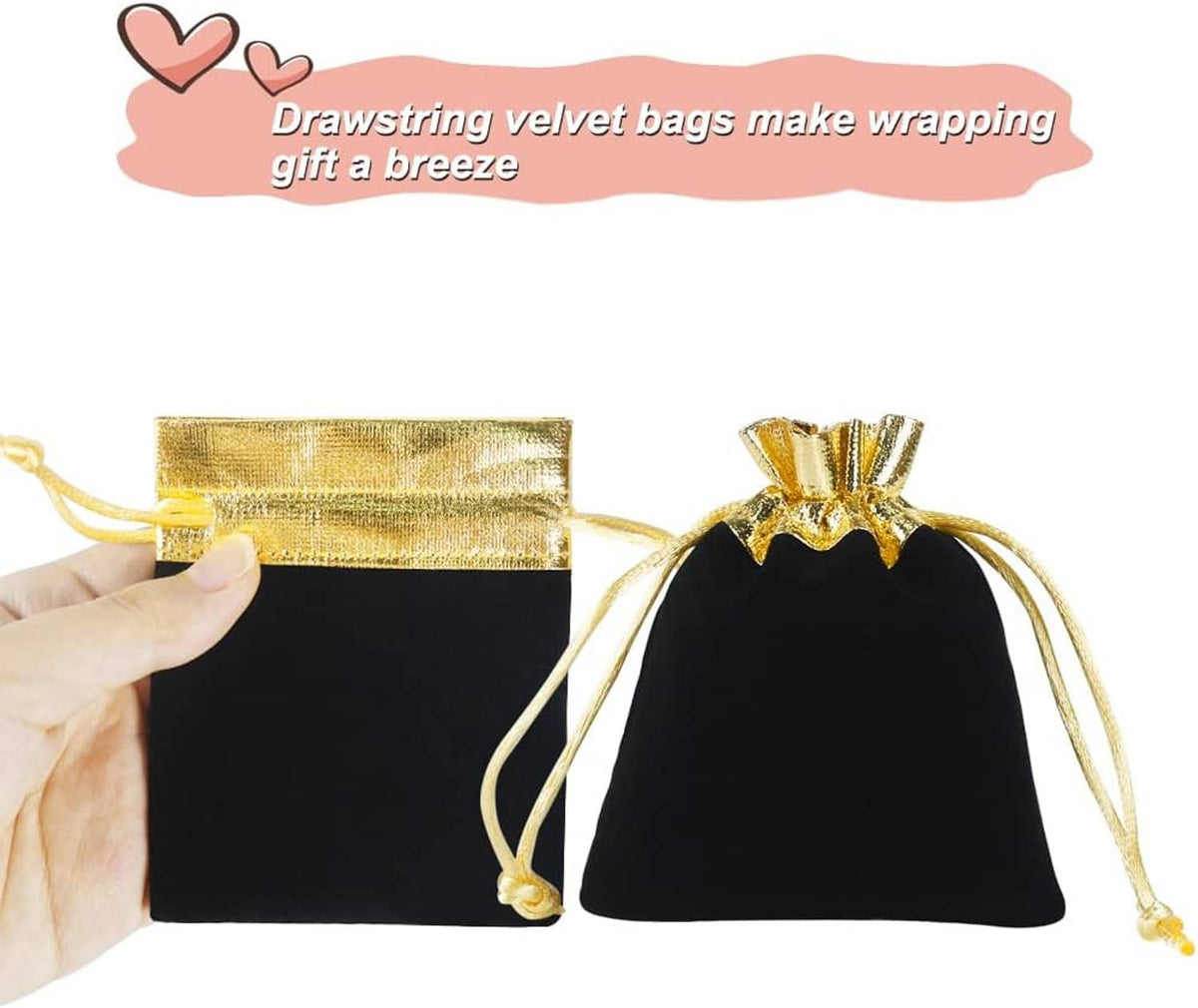 Black velvet drawstring gift pouch with gold trim and cords, shown with hand holding one