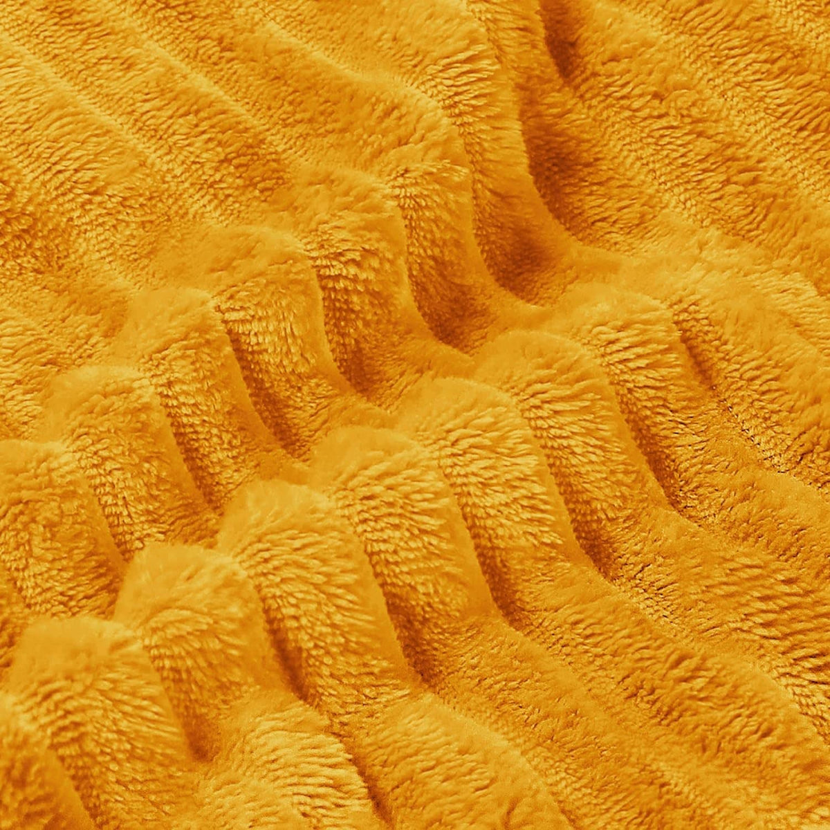 Close-up of yellow 3D ribbed jacquard fleece blanket texture