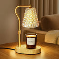 Amber-gold candle warmer lamp with glass shade, curved metal stand, wooden base