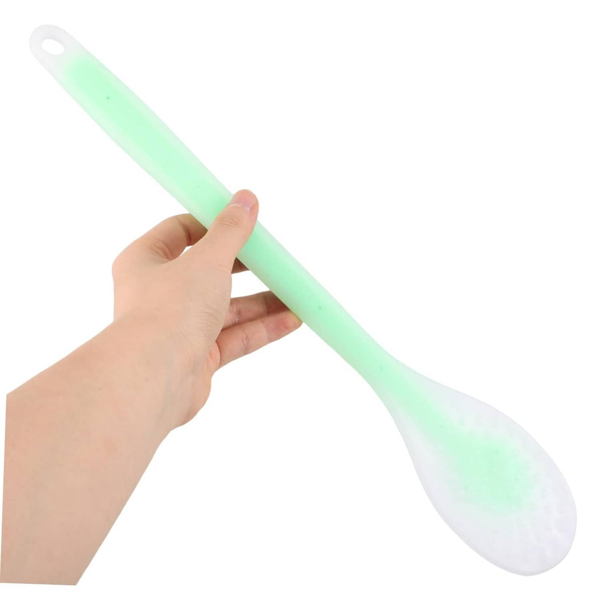 Green long-handled lotion applicator spoon held by hand, oval head and loop grip