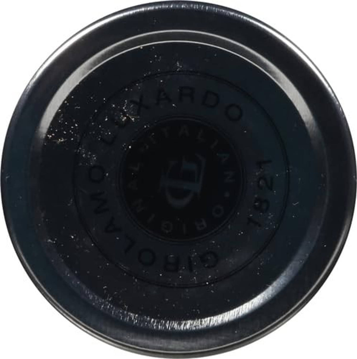 Black jar lid underside with embossed lettering and trademark seal.