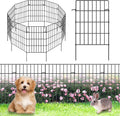Black metal garden animal barrier fence with vertical grid and stakes beside a dog and rabbit