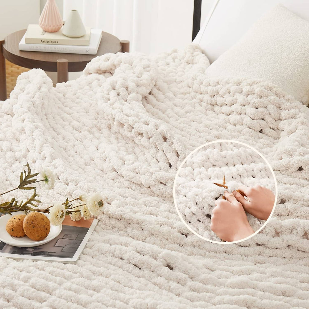Ivory chunky knit throw blanket with raised bobble texture, spread across bed