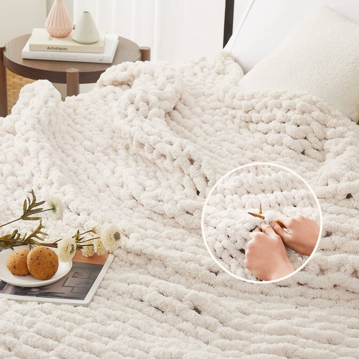 Ivory chunky knit throw blanket with raised bobble texture, spread across bed