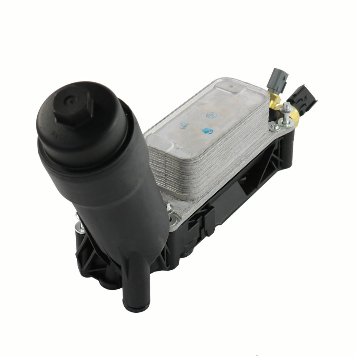 Oil filter adapter housing close-up with black cap, silver heat exchanger, and brass valve