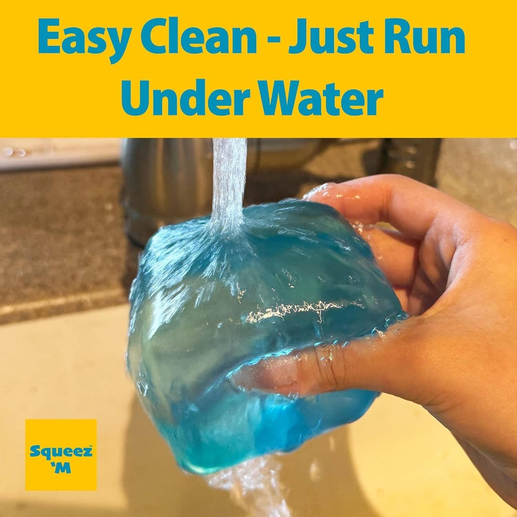 Blue large stress cube rinsed under running water by hand