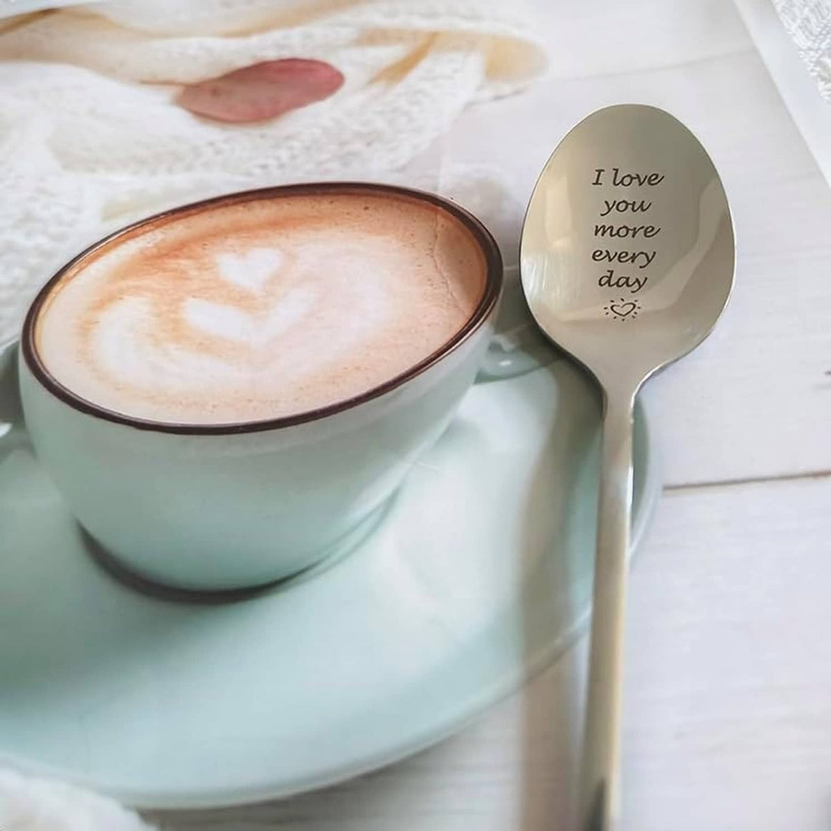 Engraved love message spoon with beige oval bowl and silver handle, 'I love you more every day'