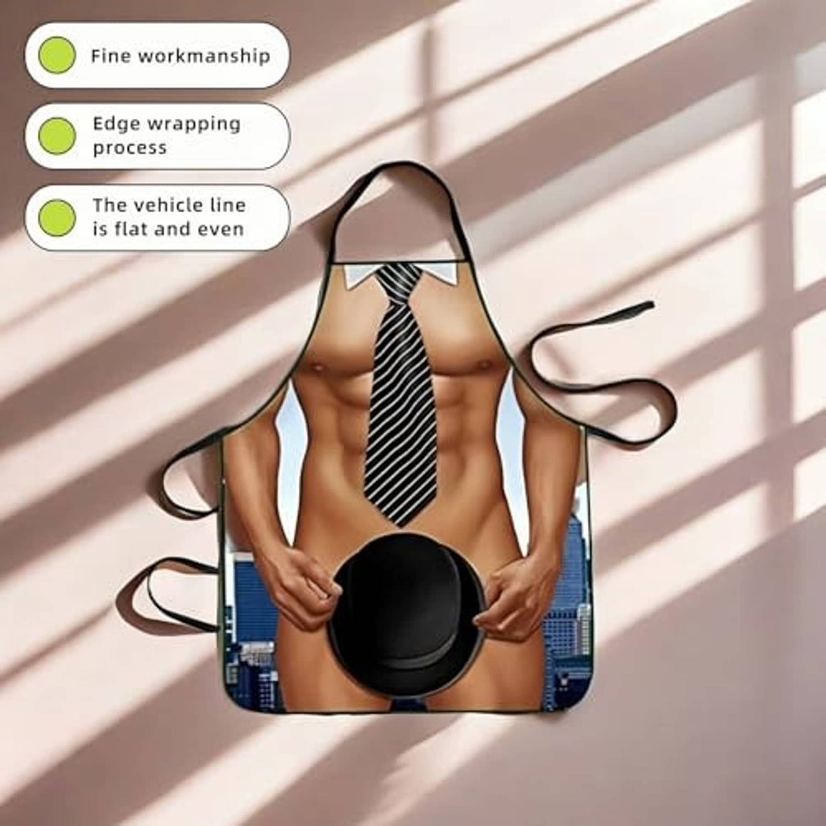 Muscle man novelty apron with striped necktie and black hat on the front panel