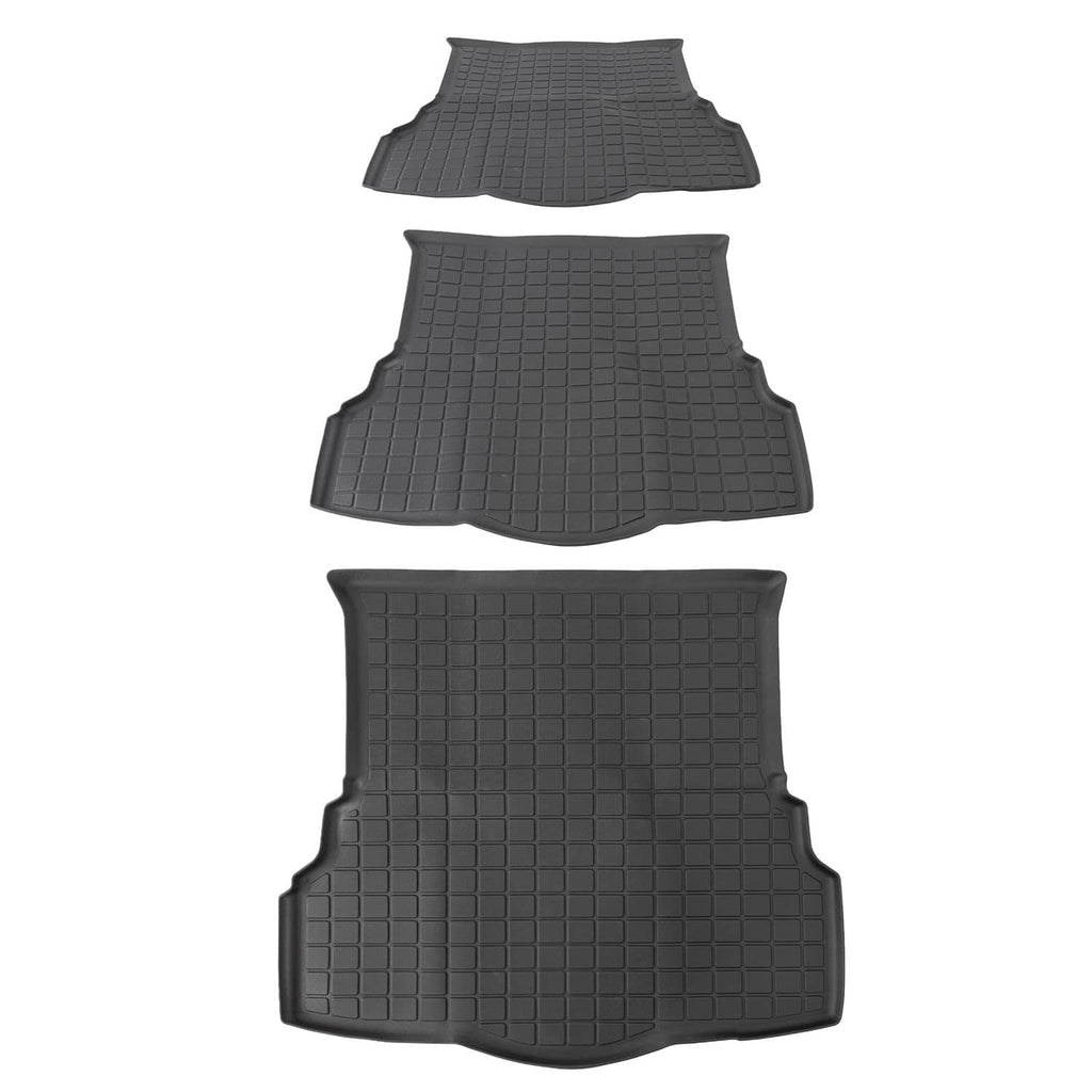 Rear-row black rubber floor mats and trunk liner with raised grid texture and molded edges