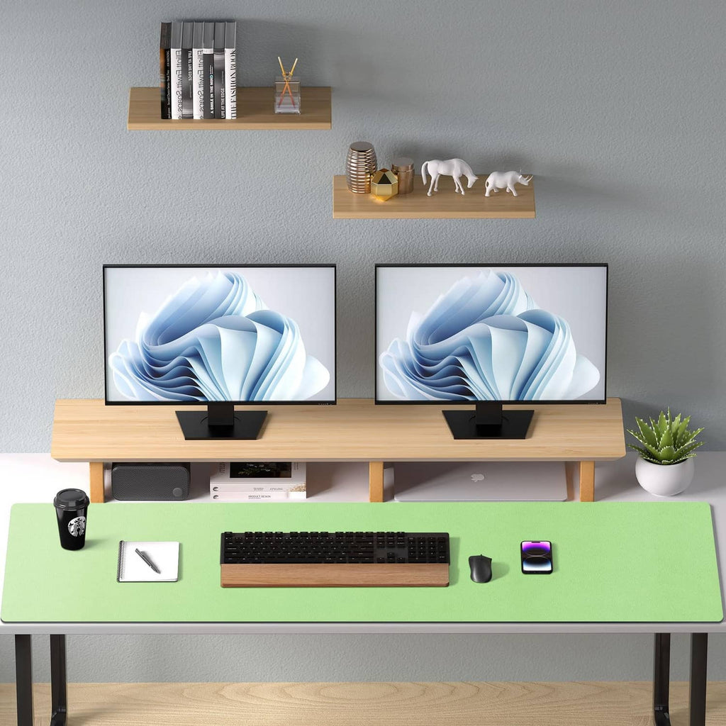 Green desk pad protector on office table, flat surface for keyboard and monitors