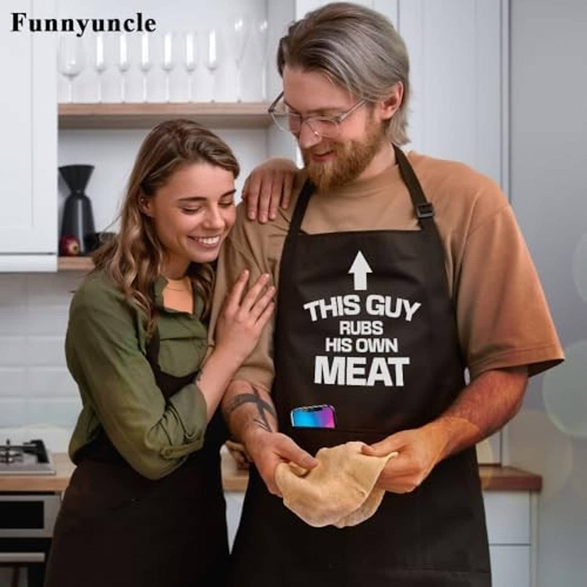 Black apron with 'THIS GUY RUBS HIS OWN MEAT' print and front pocket panel