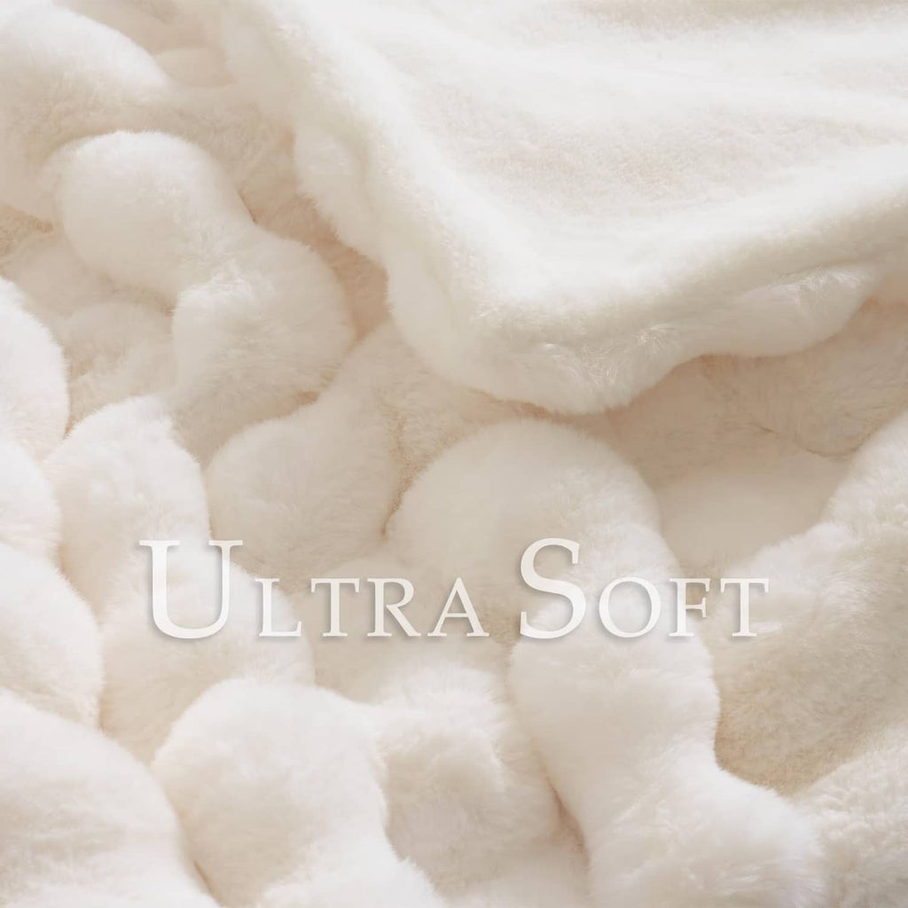 Cream faux rabbit-style fur throw with dense plush wavy pile detail