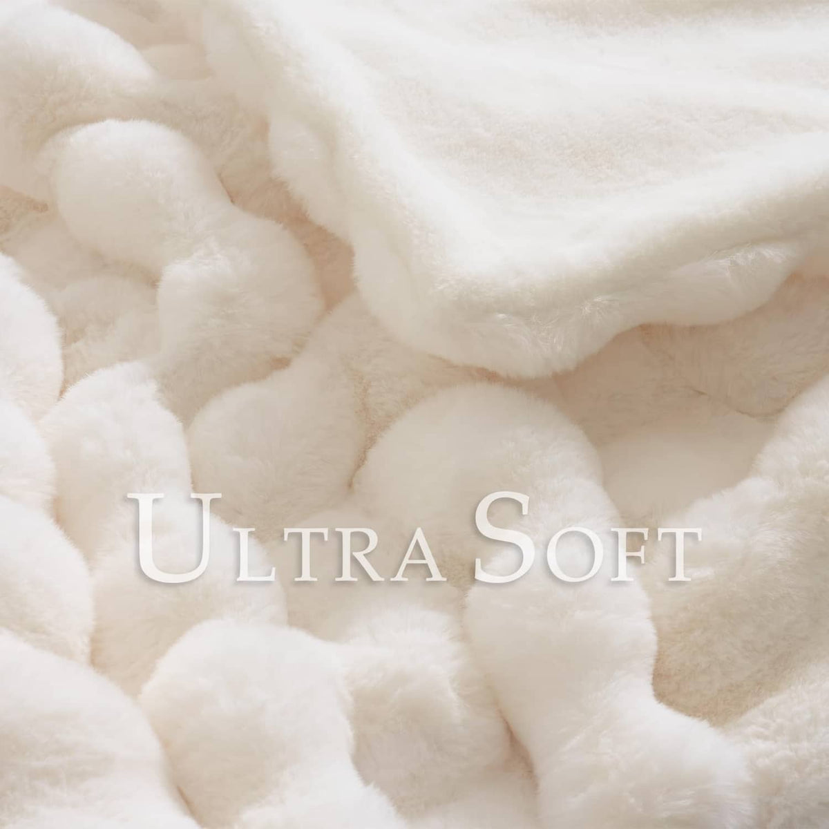 Cream faux rabbit-style fur throw with dense plush wavy pile detail