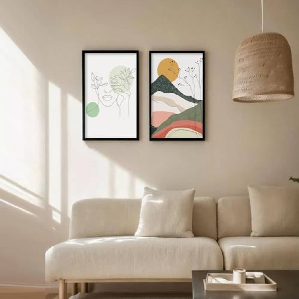 Two black 16x20 picture frames on wall above a sofa