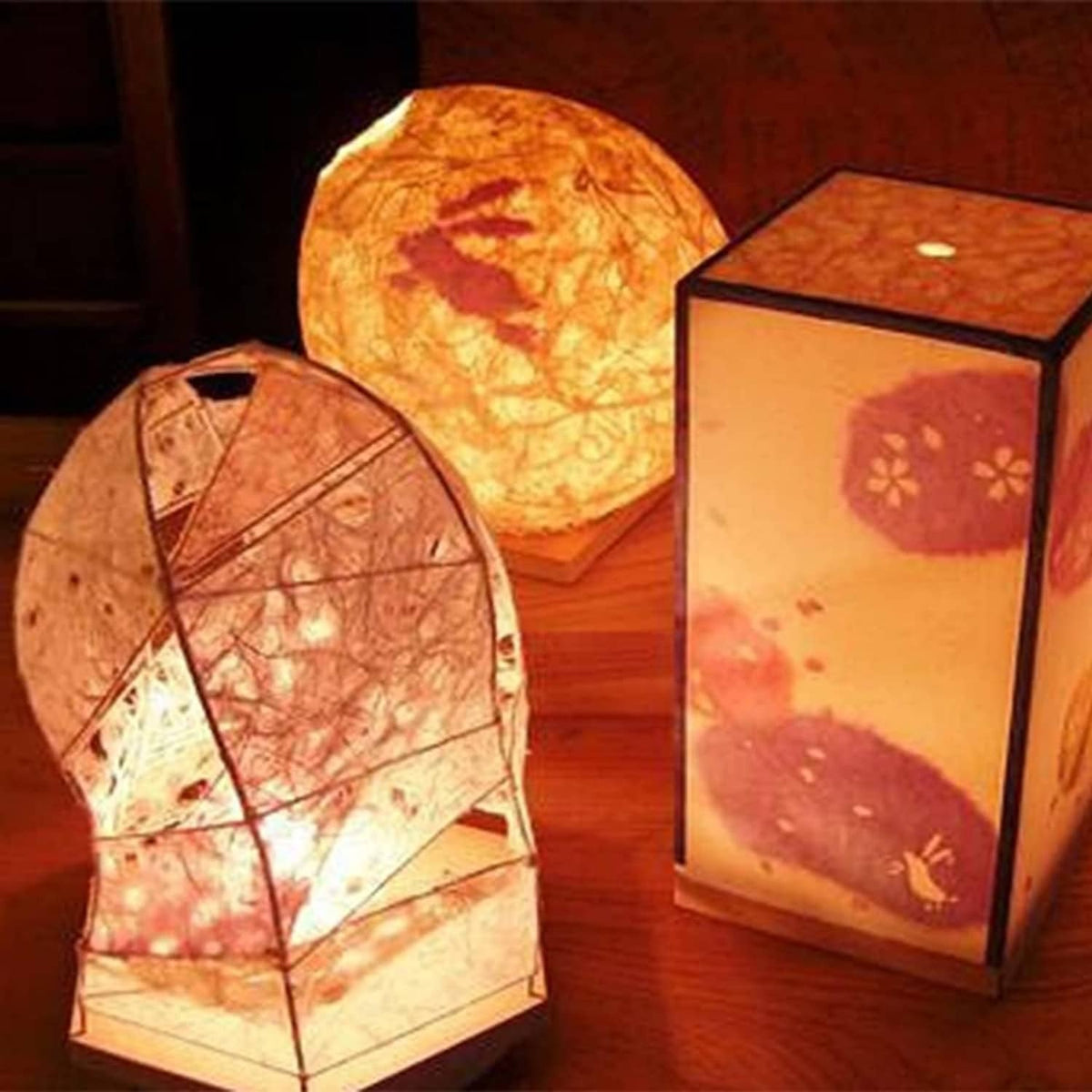 Warm-lit paper lanterns with decorative handmade paper panels