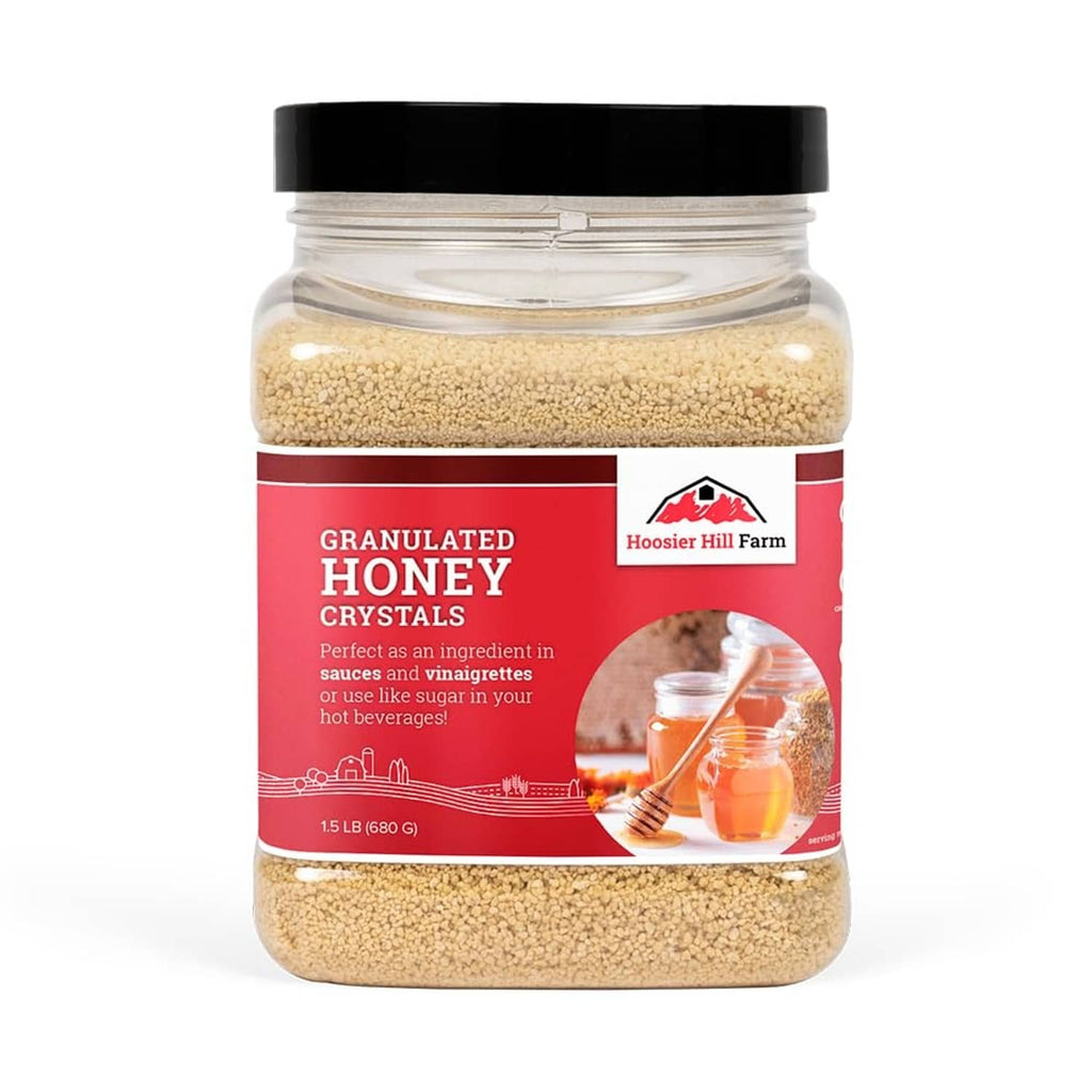 Granulated honey crystals jar with black lid and red label, light tan crystals