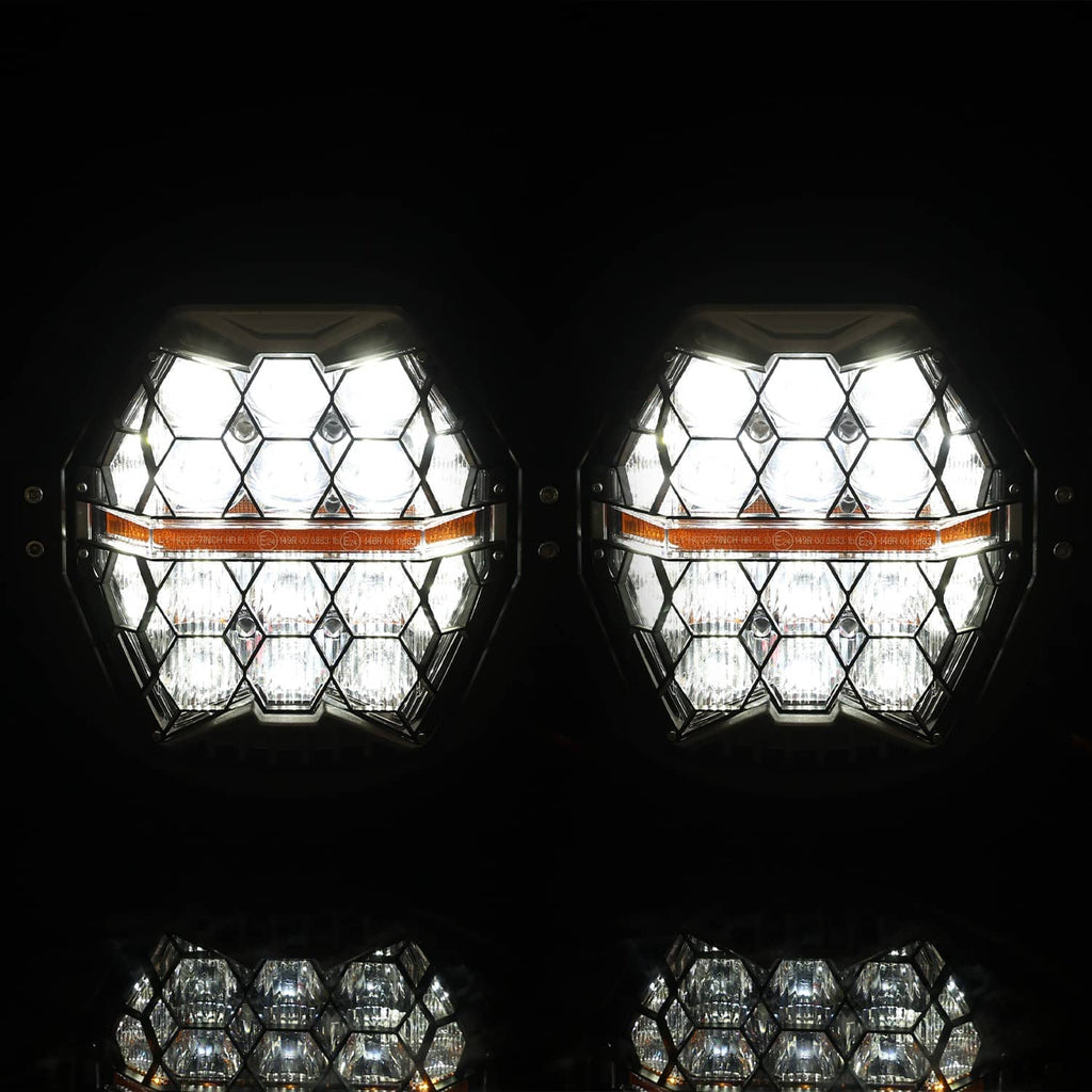 Dual LED projector headlights lit, showing bright white hex lens pattern on both units