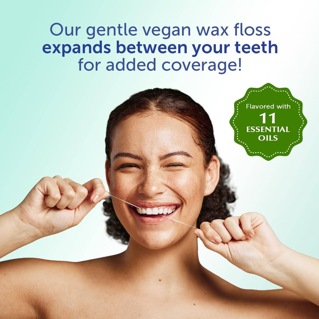 Mint waxed dental floss string held between teeth for added coverage