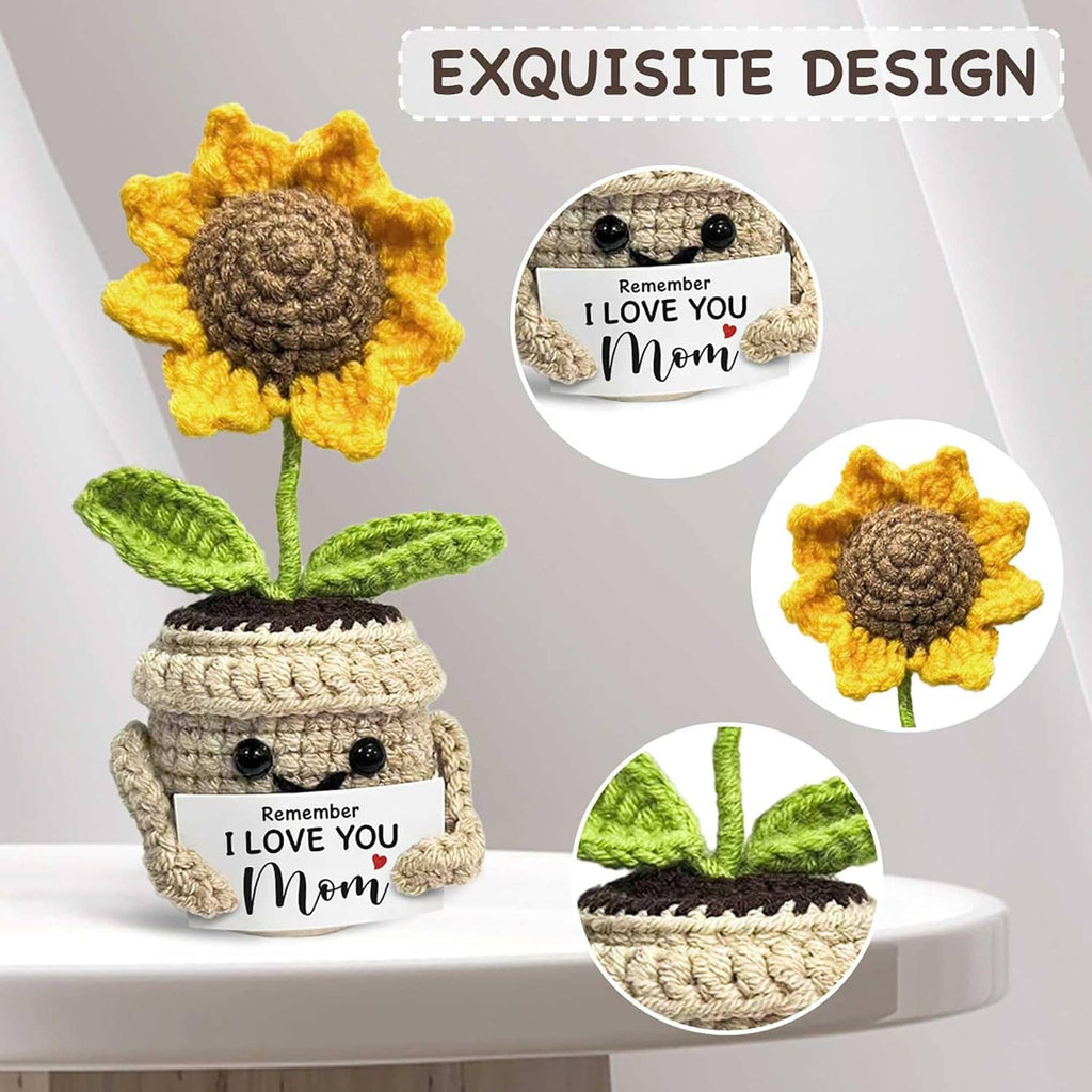 Crocheted sunflower in beige pot with yellow petals and green leaves; close-up shows 'I love you Mom' label
