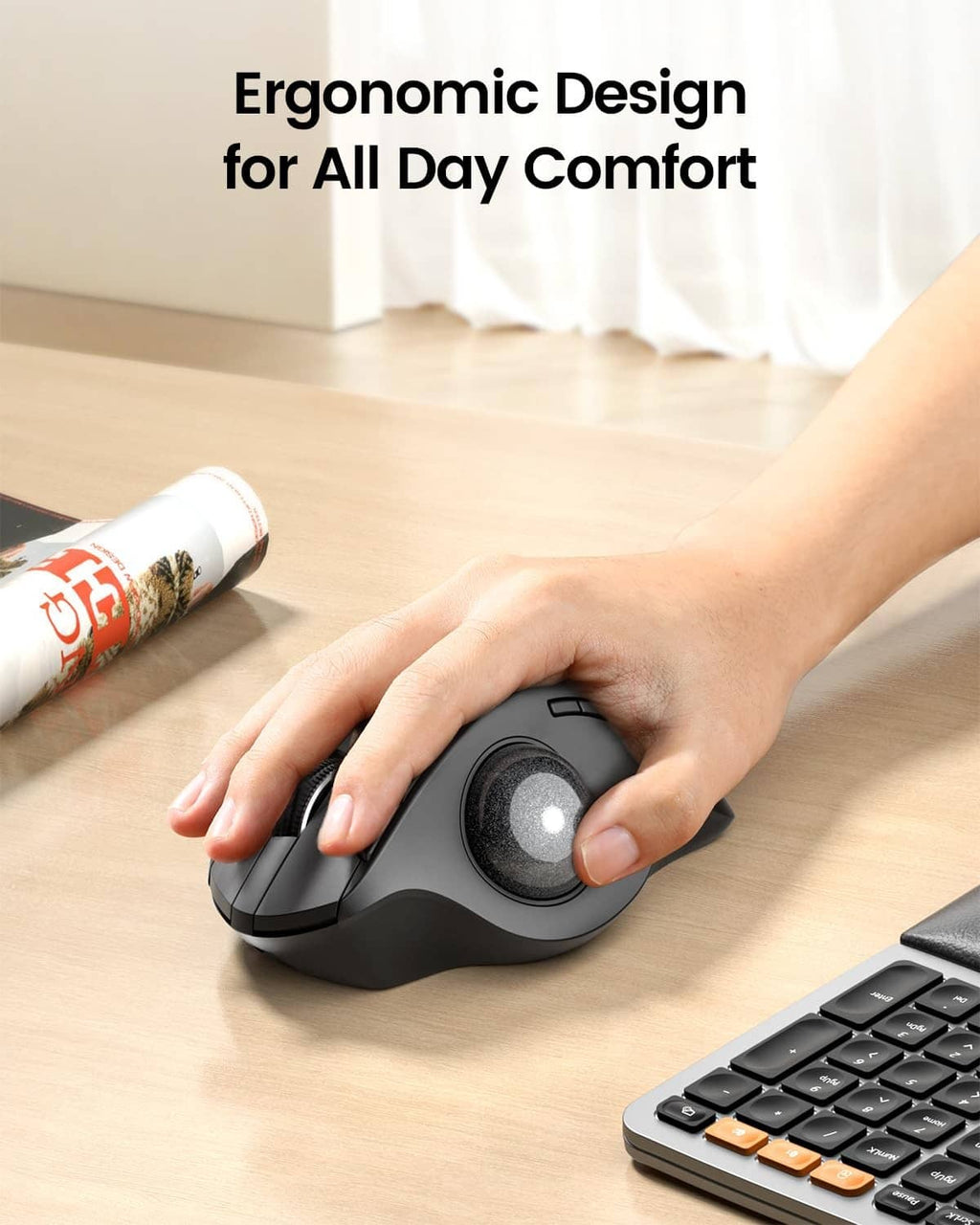 Ergonomic trackball mouse held in a hand, showing top buttons and trackball