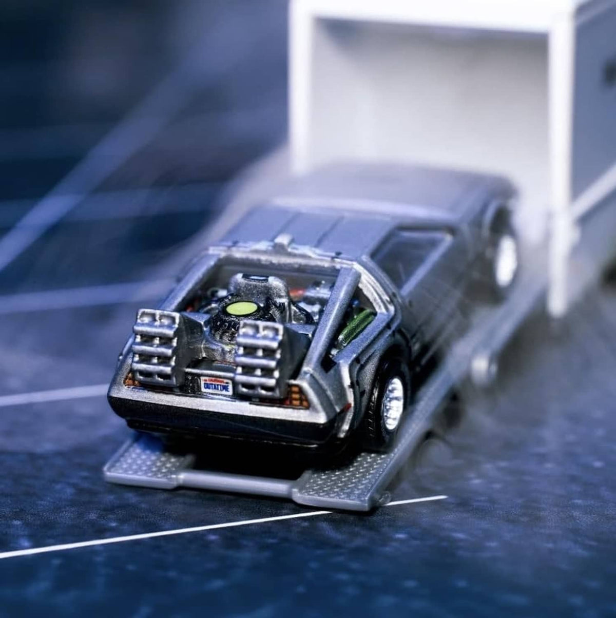 1:64 die-cast black car with open engine bay detail and chrome parts