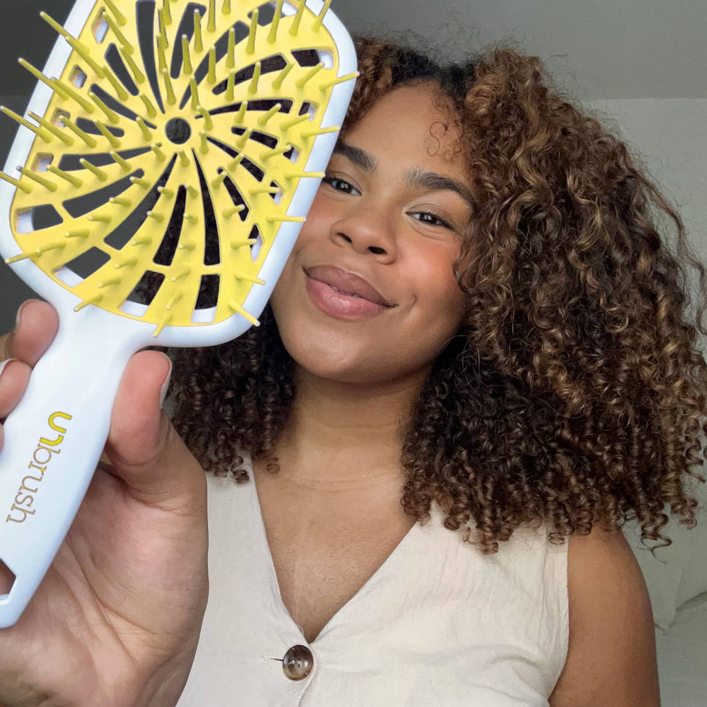 UNbrush detangling hair brush with yellow bristle head close-up in front view