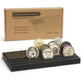 Black wooden coin display stand with five challenge coins on top